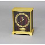 JAEGER LE COULTRE EMBASSY ATMOS CLOCK, the brass chapter ring on a red marbled ground and side