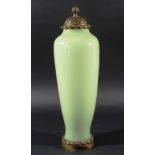 CELADON JADE GREEN GLASS AND ORMOLU VASE AND COVER, of slender shouldered form, the cover moulded