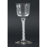 GEORGE III WINE GLASS, the ogee bowl above the stem with a central white gauze inside a double helix