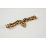 A 9CT. GOLD FANCY LINK BRACELET formed with alternate oval and gate links, each oval link set with