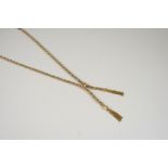 A 9CT. TWO COLOUR GOLD TASSEL NECKLACE of twisted rope design, 47cm. long, 23 grams.