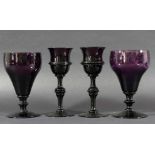 PAIR OF AMETHYST WINE GLASSES, the bell shaped bowl with a band of decoration on a stem with a large