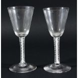 PAIR OF GEORGE III WINE GLASSES, the tapering bowls above stems with a central gauze inside a