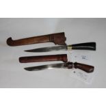 TWO RECONG KNIVES. A horn handled modern Recong knife with wooden scabbard and a 6" blade, with