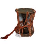 A KO-DAKO DRUM. A Japanese Ko-Dako drum of 11.3/4" height and 9" circumference. Bound with silk ties