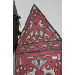 A DYAK SHIELD. A carved Dyak shield with intricately carved front, decorated in red and white native