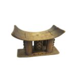 ASHANTI TRIBAL HEAD REST a wooden head rest with a curved top, with incised and carved motifs and