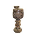 AFRICAN TRIBAL FIGURE a Nigerian hardwood wooden figure carrying a basket on it's head, with a