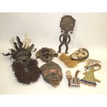 TRIBAL MASKS a variety of tribal masks including one with a feather headdress, one mounted with