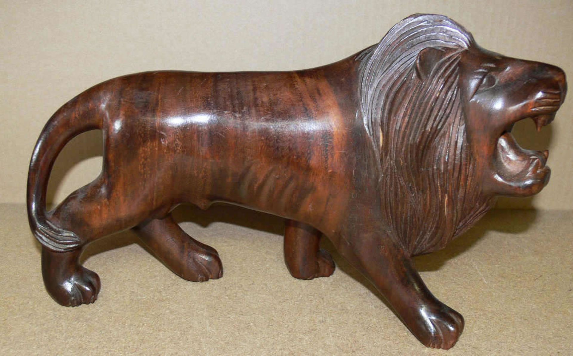Holz - Skulptur "Löwe". L: ca. 35 cm. H: ca. 23 cm. Mit kleinen Bereibungen.