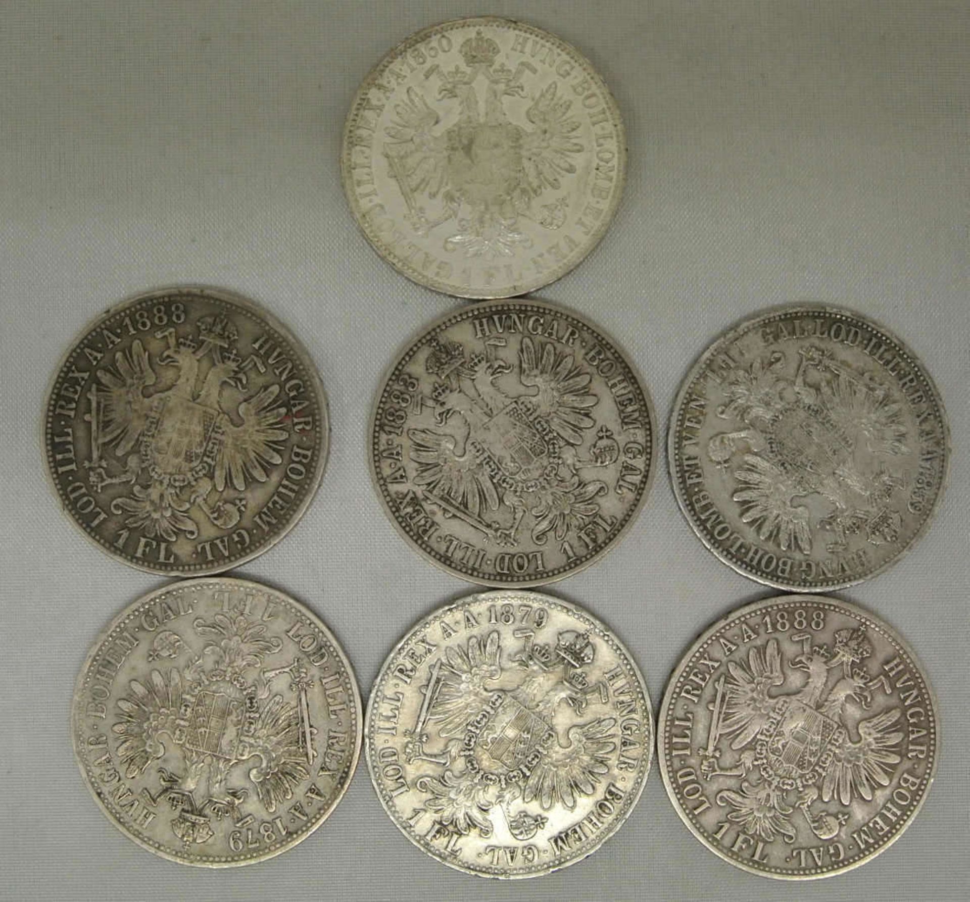 Lot Österreich Münzen, 7x 1 Florin/Gulden, dabei 1x 1859, 1x 1860, 2x 1879, 1x 1883, 2x 1888.