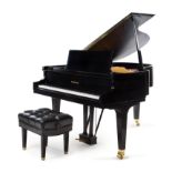 A Baldwin Black Lacquer Baby Grand Piano Length of case 55 3/4 inches.