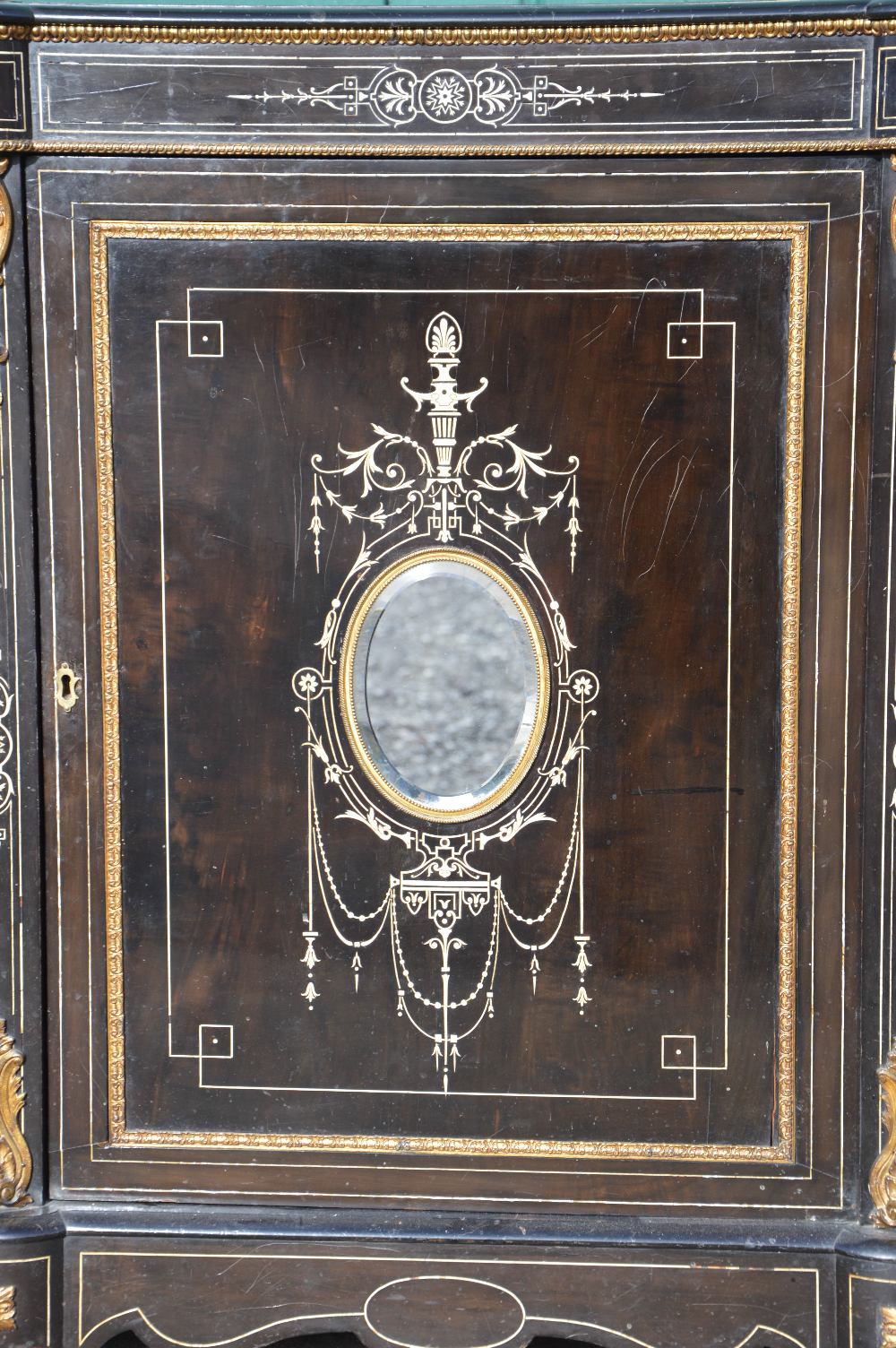 A Victorian ebonised, ivory inlaid and ormolu mounted credenza, the central panelled cupboard door - Image 2 of 3