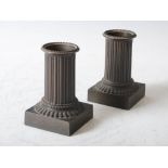 A pair of early 19th century bronze quill pots in the form of fluted Classical columns, on square