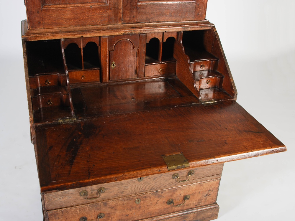 A George III oak bureau bookcase, the double domed moulded cornice above a pair of panelled cupboard - Image 3 of 6