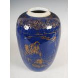 A Chinese porcelain powder blue ground jar, Qing Dynasty, decorated with gilded panels of figures on