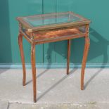 A late 19th century Louis XV style mahogany and ormolu mounted bijouterie table, the hinged cover