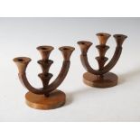 A pair of Cotswold School Art Deco walnut three light candelabra, on circular plinth bases, 16cm