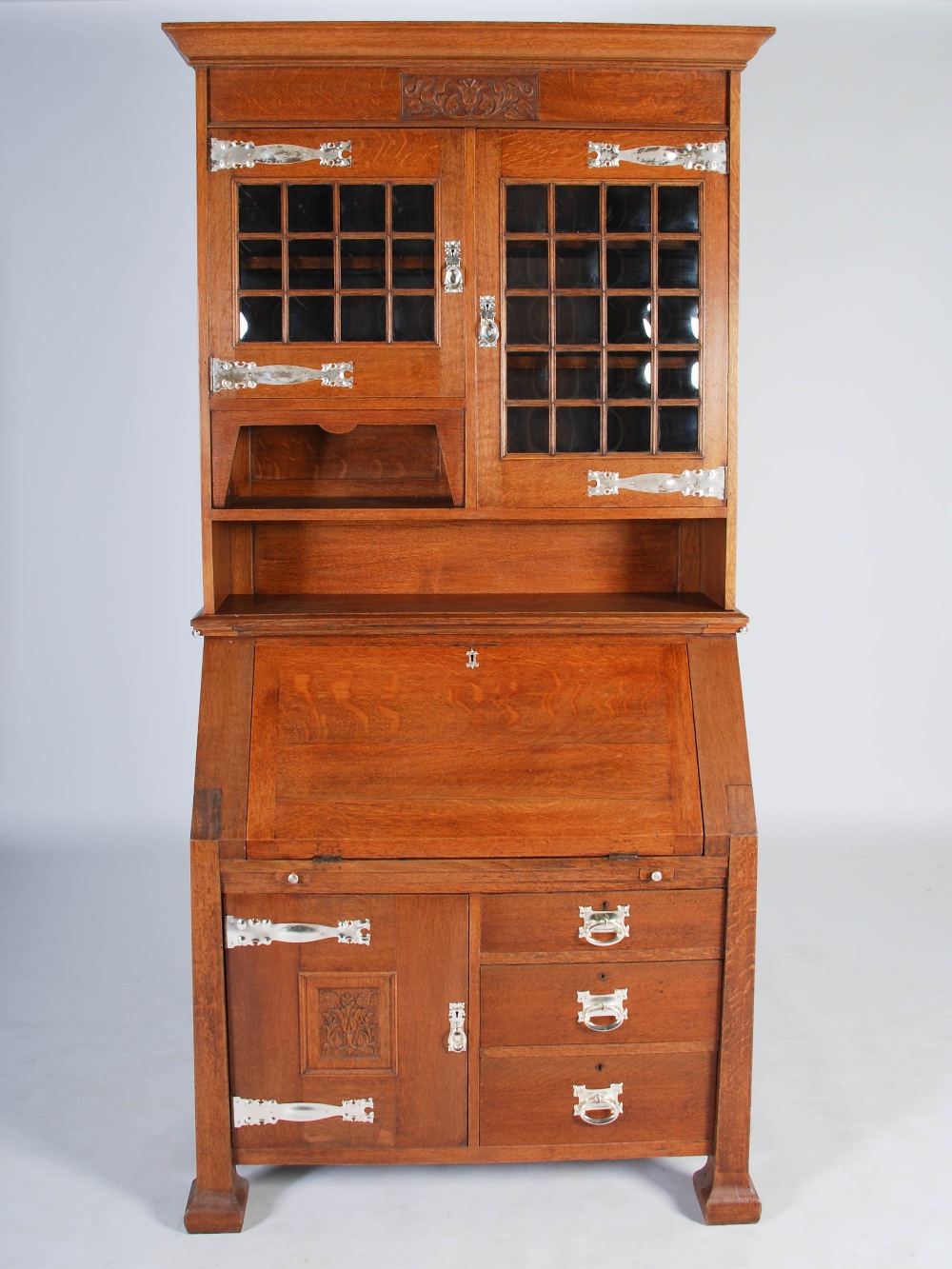 An oak Arts & Crafts style bureau bookcase, the moulded cornice above a plain frieze centred with - Image 4 of 7