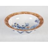 A Japanese Fukagawa porcelain bowl, the interior decorated with peony and other flowers within a