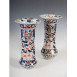 A pair of Japanese Imari vases, Edo period, decorated with urns issuing peony and other flowers