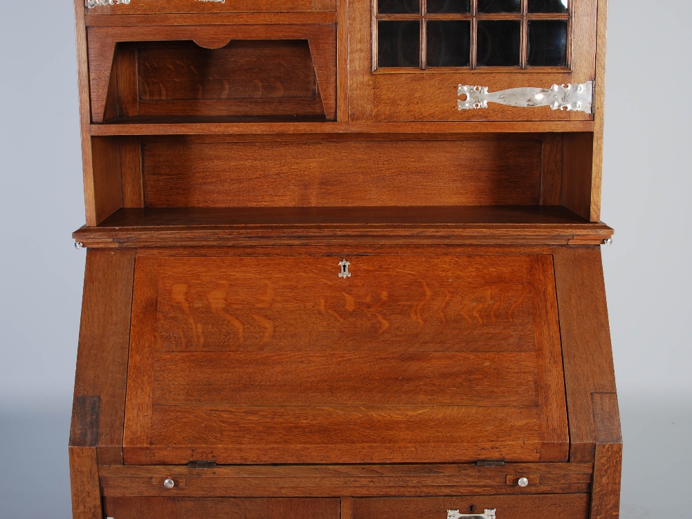 An oak Arts & Crafts style bureau bookcase, the moulded cornice above a plain frieze centred with - Image 6 of 7