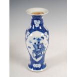 A Chinese porcelain blue and white vase, Qing Dynasty, decorated with oval shaped panels of altar