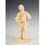 A Japanese sectional ivory okimono of an elderly farm worker, Meiji period, 15.5cm high.