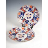 A pair of early 20th century Japanese Imari chargers, decorated with central circular shaped