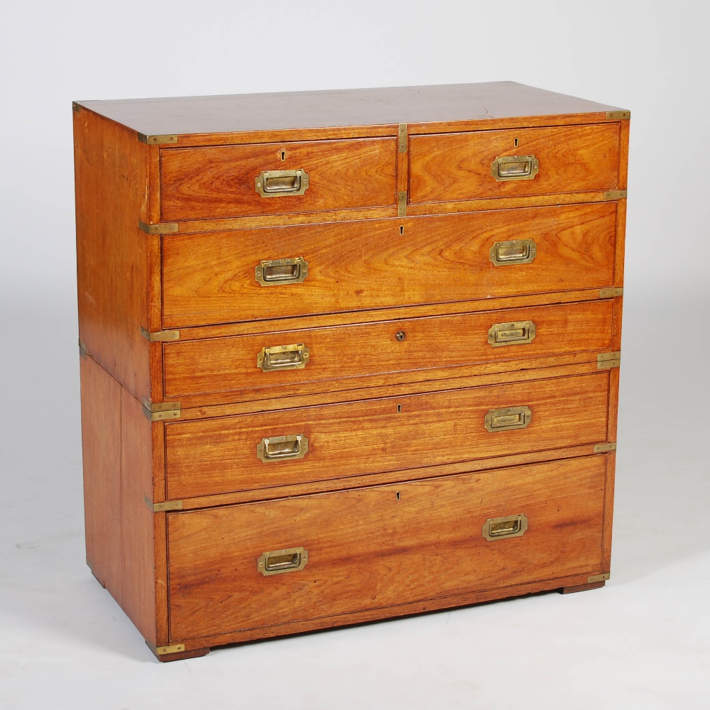 A 19th century teak and brass bound two part secretaire chest, the upper section with two short