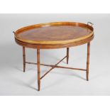 A 19th century mahogany, satinwood and marquetry inlaid oval tray on stand, the twin handled tray