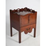 A George III mahogany tray top commode, the rectangular top with a pierced gallery above a pair of