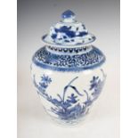 A Japanese blue and white Arita porcelain jar and cover, Edo period, decorated with rock work, peony