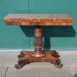 A 19th century rosewood card table, the rectangular top opening to a green baize lined interior,