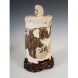 A Japanese ivory tusk vase and cover, Meiji period, the vase carved in relief with a bull elephant