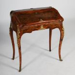 A late 19th century walnut and ormolu mounted bureau de dame, the slightly bombe fall front