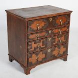 A Charles II style oak chest, the rectangular top with a moulded edge above four long drawers with