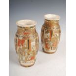 A pair of late 19th/early 20th century Japanese Satsuma pottery vases, decorated with panels of