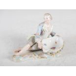 A Meissen porcelain figural sweet meat dish, modelled with reclining gentleman holding a floral