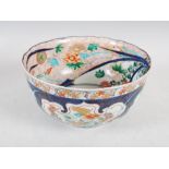 A Japanese Imari bowl, Edo period, the exterior decorated with four shaped panels enclosing peony
