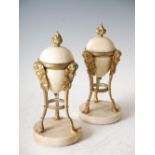 A pair of late 19th century ormolu and white marble urns, with three satyr caryatid supports, on