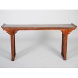 A Chinese altar table, the rectangular top with scroll carved ends, raised on rectangular section