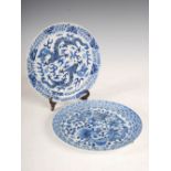 Two Chinese blue and white porcelain plates, Qing Dynasty, one decorated with a pair of dragons