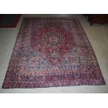 A Persian carpet, Kirman, the rectangular ground centred with a large flower head medallion within a