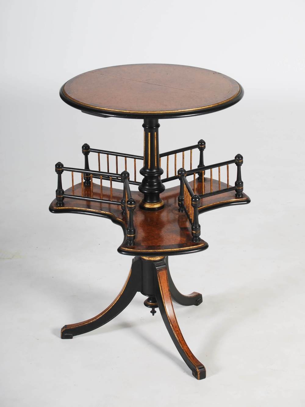 A Victorian amboyna and ebonised occasional table, the circular top raised on an ebonised column