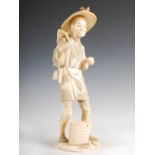 A Japanese sectional ivory okimono of a farmer, Meiji period, 32.5cm high.