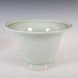 A Chinese porcelain celadon glazed jardiniere, the tapered cylindrical body decorated in shallow