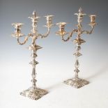 A pair of late 19th century electroplated three light candelabra, the foliate cast scroll arms