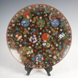 A Japanese cloisonne charger, Meiji period, decorated with ball flowers, 30cm diameter.