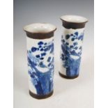 A pair of Chinese porcelain blue and white crackle glazed sleeve vases, decorated with rock work,
